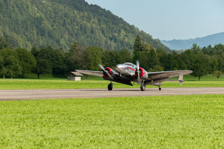 Mollis, Switzerland, August 18, 2023 NC-81125 Lockheed Model 12 Electra Junior aircraft is taxiing on the runwayのeditorial素材