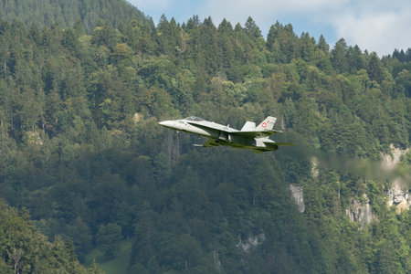Mollis, Switzerland, August 18, 2023 Swiss military McDonnell Douglas F/A-18 Hornet jet is performing acrobatics during an air displayのeditorial素材