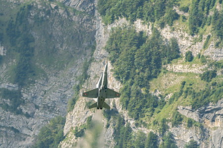 Mollis, Switzerland, August 18, 2023 Swiss military McDonnell Douglas F/A-18 Hornet jet is performing acrobatics during an air displayのeditorial素材