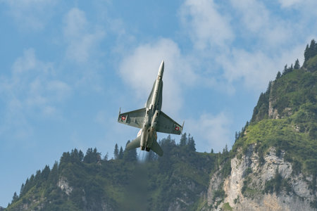 Mollis, Switzerland, August 18, 2023 Swiss military McDonnell Douglas F/A-18 Hornet jet is performing acrobatics during an air displayのeditorial素材