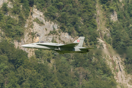 Mollis, Switzerland, August 18, 2023 Swiss military McDonnell Douglas F/A-18 Hornet jet is performing acrobatics during an air displayのeditorial素材