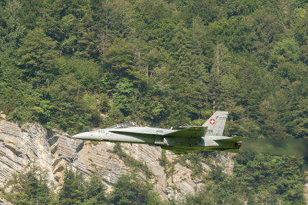 Mollis, Switzerland, August 18, 2023 Swiss military McDonnell Douglas F/A-18 Hornet jet is performing acrobatics during an air displayのeditorial素材