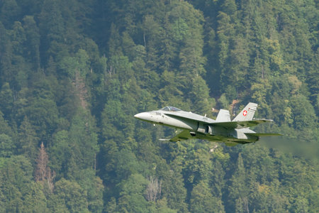 Mollis, Switzerland, August 18, 2023 Swiss military McDonnell Douglas F/A-18 Hornet jet is performing acrobatics during an air displayのeditorial素材