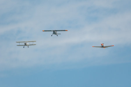 Mollis, Switzerland, August 18, 2023 Boeing E75 Stearman with a Dornier 27 and a Pilatus P-3-05 aircraft in formation flight during an air showのeditorial素材