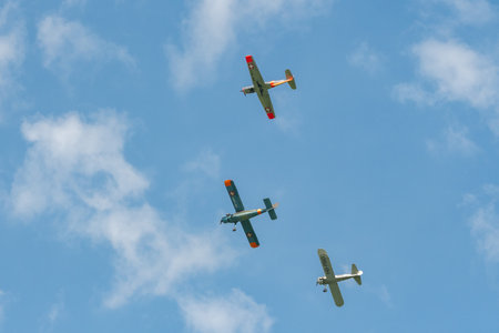 Mollis, Switzerland, August 18, 2023 Boeing E75 Stearman with a Dornier 27 and a Pilatus P-3-05 aircraft in formation flight during an air showのeditorial素材