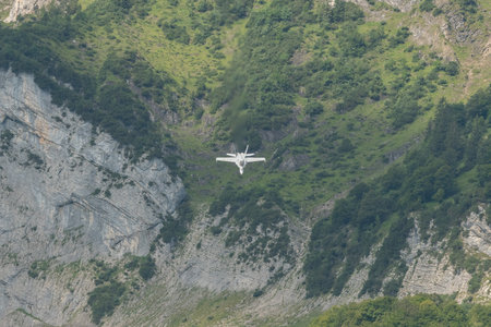 Mollis, Switzerland, August 18, 2023 Swiss military McDonnell Douglas F/A-18 Hornet jet is performing acrobatics during an air displayのeditorial素材