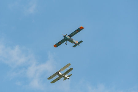Mollis, Switzerland, August 18, 2023 Boeing E75 Stearman and a Dornier 27 aircraft in formation flight during an air showのeditorial素材
