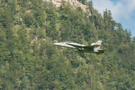 Mollis, Switzerland, August 18, 2023 Swiss military McDonnell Douglas F/A-18 Hornet jet is performing acrobatics during an air displayのeditorial素材