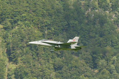 Mollis, Switzerland, August 18, 2023 Swiss military McDonnell Douglas F/A-18 Hornet jet is performing acrobatics during an air displayのeditorial素材