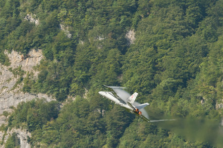 Mollis, Switzerland, August 18, 2023 Swiss military McDonnell Douglas F/A-18 Hornet jet is performing acrobatics during an air displayのeditorial素材