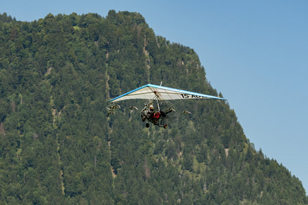 Mollis, Switzerland, August 18, 2023 Ultralight airplane is escorted with birds during an air displayのeditorial素材