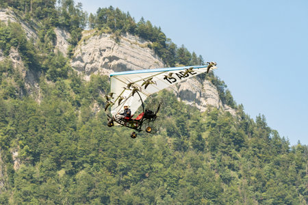 Mollis, Switzerland, August 18, 2023 Ultralight airplane is escorted with birds during an air displayのeditorial素材