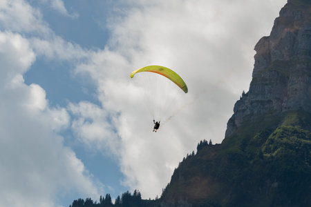 Mollis, Switzerland, August 18, 2023 Parachute performance in an alpine scenery during an air displayのeditorial素材