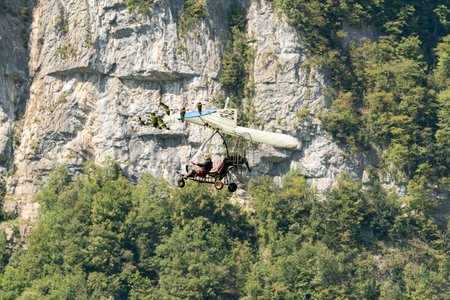 Mollis, Switzerland, August 18, 2023 Ultralight airplane is escorted with birds during an air displayのeditorial素材