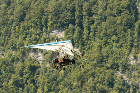 Mollis, Switzerland, August 18, 2023 Ultralight airplane is escorted with birds during an air displayのeditorial素材
