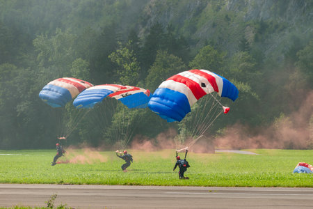 Mollis, Switzerland, August 18, 2023 RAF Falcons Parachuters are doing a performance with a lot of smoke during an air displayのeditorial素材