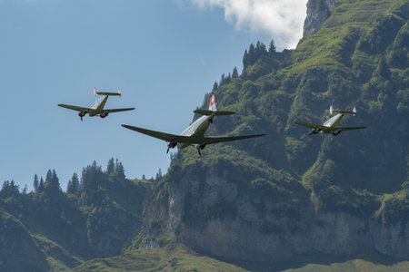 Mollis, Switzerland, August 18, 2023 Douglas DC-3C and Beechcraft Model 18 nostalgic aircraft performance during an air showのeditorial素材
