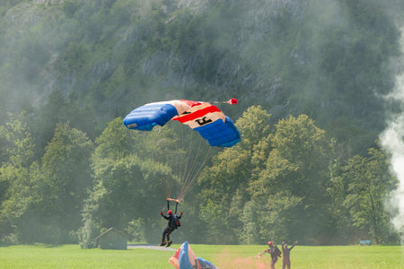 Mollis, Switzerland, August 18, 2023 RAF Falcons Parachuters are doing a performance with a lot of smoke during an air displayのeditorial素材