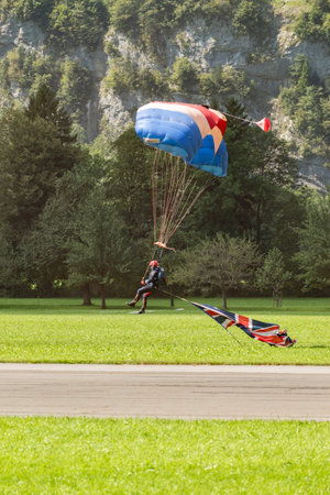 Mollis, Switzerland, August 18, 2023 RAF Falcons Parachuter with a waving Union Jack flag during an air showのeditorial素材
