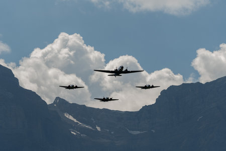 Mollis, Switzerland, August 18, 2023 Douglas DC-3C and Beechcraft Model 18 nostalgic aircraft performance during an air showのeditorial素材