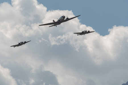 Mollis, Switzerland, August 18, 2023 Douglas DC-3C and Beechcraft Model 18 nostalgic aircraft performance during an air showのeditorial素材