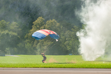 Mollis, Switzerland, August 18, 2023 RAF Falcons Parachuters are doing a performance with a lot of smoke during an air displayのeditorial素材