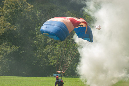 Mollis, Switzerland, August 18, 2023 RAF Falcons Parachuters are doing a performance with a lot of smoke during an air displayのeditorial素材