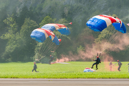 Mollis, Switzerland, August 18, 2023 RAF Falcons Parachuters are doing a performance with a lot of smoke during an air displayのeditorial素材