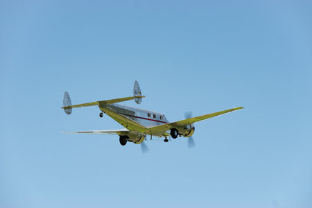 Mollis, Switzerland, August 18, 2023 NC-18125 Lockheed Model 12 Electra Junior historic aircraft is taking off from runway 01のeditorial素材