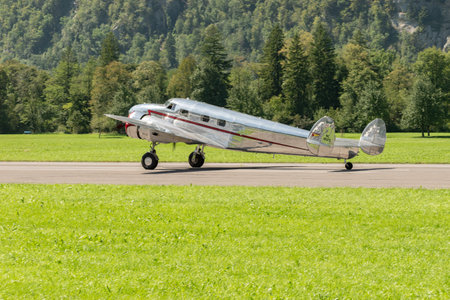 Mollis, Switzerland, August 18, 2023 NC-18125 Lockheed Model 12 Electra Junior aircraft is taxiing on the runwayのeditorial素材