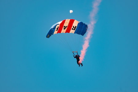 Mollis, Switzerland, August 18, 2023 RAF Falcons Parachuters are doing a performance with a lot of smoke during an air displayのeditorial素材