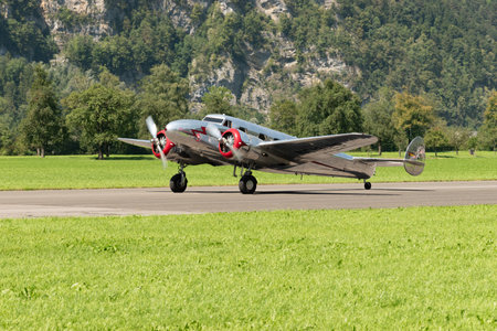 Mollis, Switzerland, August 18, 2023 NC-18125 Lockheed Model 12 Electra Junior aircraft is taxiing on the runwayのeditorial素材