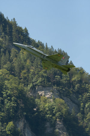 Mollis, Switzerland, August 18, 2023 Swiss military McDonnell Douglas F/A-18 hornet fighter is doing performances during an air displayのeditorial素材