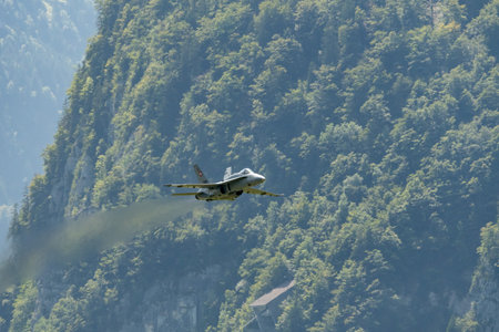 Mollis, Switzerland, August 18, 2023 Swiss military McDonnell Douglas F/A-18 hornet fighter is doing performances during an air displayのeditorial素材