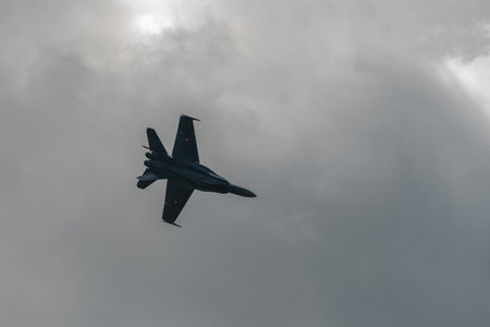 Mollis, Switzerland, August 18, 2023 Swiss military McDonnell Douglas F/A-18 hornet fighter is doing performances during an air displayのeditorial素材