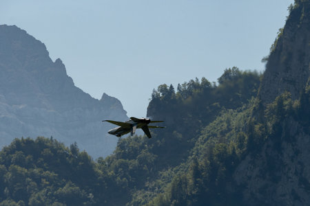 Mollis, Switzerland, August 18, 2023 Swiss military McDonnell Douglas F/A-18 hornet fighter is doing performances during an air displayのeditorial素材