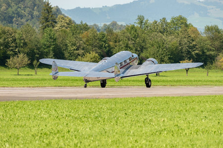 Mollis, Switzerland, August 18, 2023 NC-18125 Lockheed Model 12 Electra Junior historic aircraft is taxiing on the runwayのeditorial素材