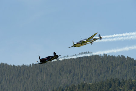 Mollis, Switzerland, August 18, 2023 Lockheed P-38L Lightning and a Chance Vought F4U-4 Corsair...