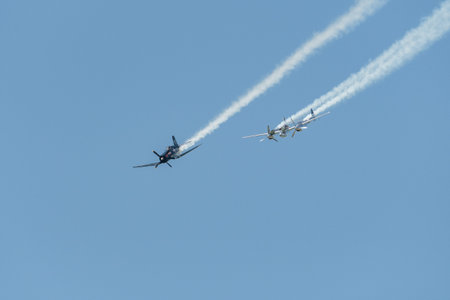 Mollis, Switzerland, August 18, 2023 Lockheed P-38L Lightning and a Chance Vought F4U-4 Corsair historic aircraft in formation flight during an air showのeditorial素材