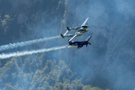 Mollis, Switzerland, August 18, 2023 Lockheed P-38L Lightning and a Chance Vought F4U-4 Corsair historic aircraft in formation flight during an air showのeditorial素材