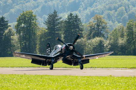 Mollis, Switzerland, August 18, 2023 OE-EAS Chance Vought F4U-4 Corsair historic aircraft is taxiing on the runwayのeditorial素材