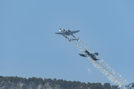 Mollis, Switzerland, August 18, 2023 Lockheed P-38L Lightning and a Chance Vought F4U-4 Corsair historic aircraft in formation flight during an air displayのeditorial素材
