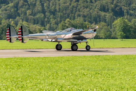 Mollis, Switzerland, August 18, 2023 N-25Y Lockheed P-38L Lightning historic aircraft is taxiing on the runwayのeditorial素材