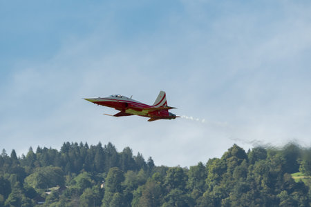 Mollis, Switzerland, August 18, 2023 Patrouille Suisse Northrop F-5E Tiger II military jet doing acrobatic flights during an air displayのeditorial素材