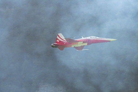 Mollis, Switzerland, August 18, 2023 Patrouille Suisse Northrop F-5E Tiger II military jet doing acrobatic flights during an air displayのeditorial素材