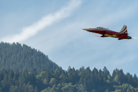 Mollis, Switzerland, August 18, 2023 Patrouille Suisse Northrop F-5E Tiger II military jet doing acrobatic flights during an air displayのeditorial素材