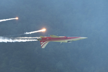 Mollis, Switzerland, August 18, 2023 Patrouille Suisse Northrop F-5E Tiger II military jet doing acrobatic flights during an air displayのeditorial素材