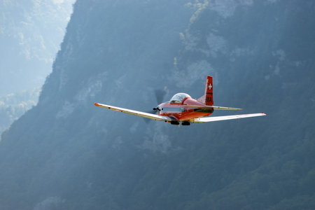 Mollis, Switzerland, August 18, 2023 Pilatus PC-7 aircraft is departing from runway 19のeditorial素材
