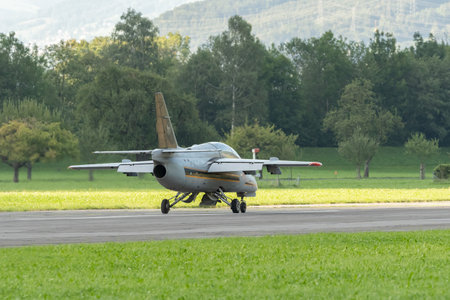 Mollis, Switzerland, August 18, 2023 I-MJET SIAI 211 aircraft is landing on runway 01のeditorial素材
