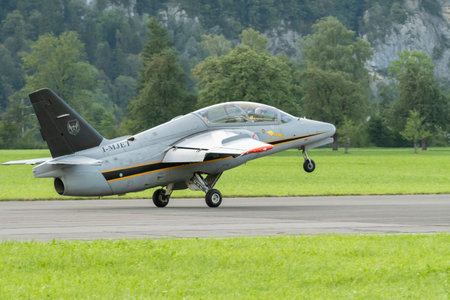 Mollis, Switzerland, August 18, 2023 I-MJET SIAI 211 aircraft is landing on runway 01のeditorial素材